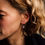 Thumbnail: Model wearing a pair of amethyst drop earrings