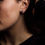 Thumbnail: Woman wearing a pair of aquamarine stud earrings