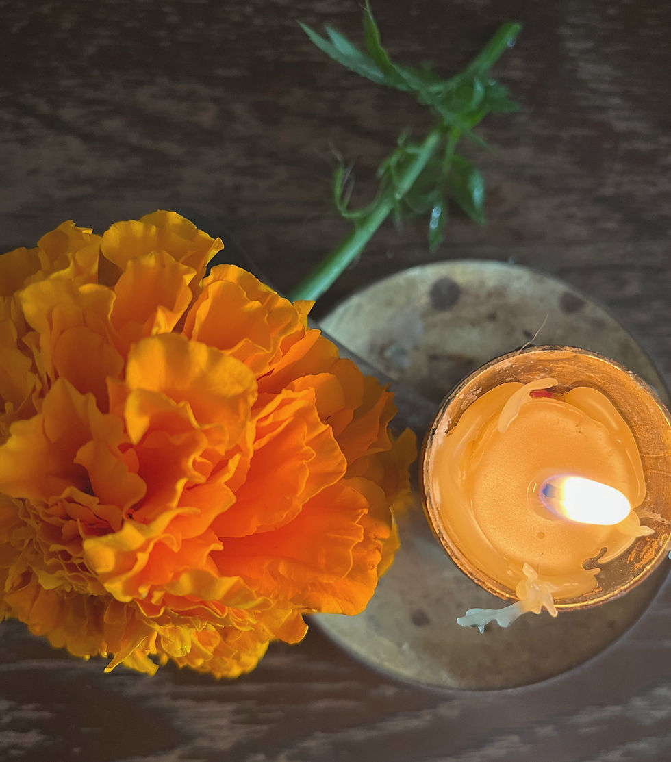 cempasúchil and a candle