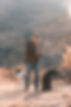 Dallin is standing holding a shot gun with two gun dogs by his side