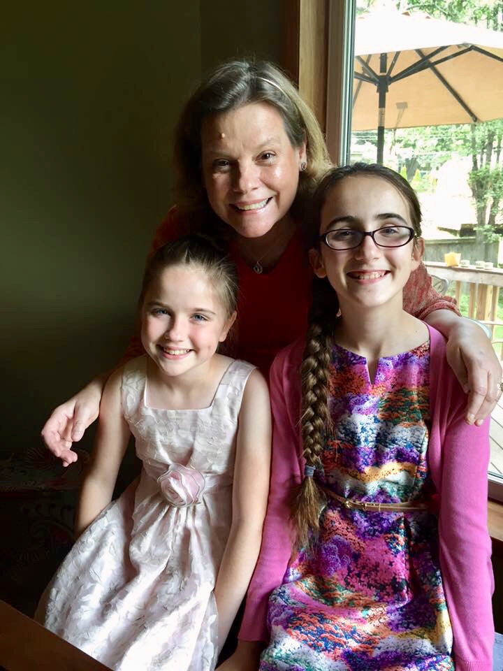 Kate poses with two of her piano students, siblings girls