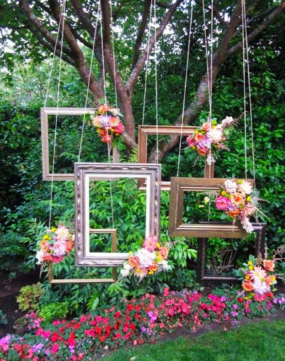 a bunch of small frames hanging to make an interesting Photo Booth at a wedding