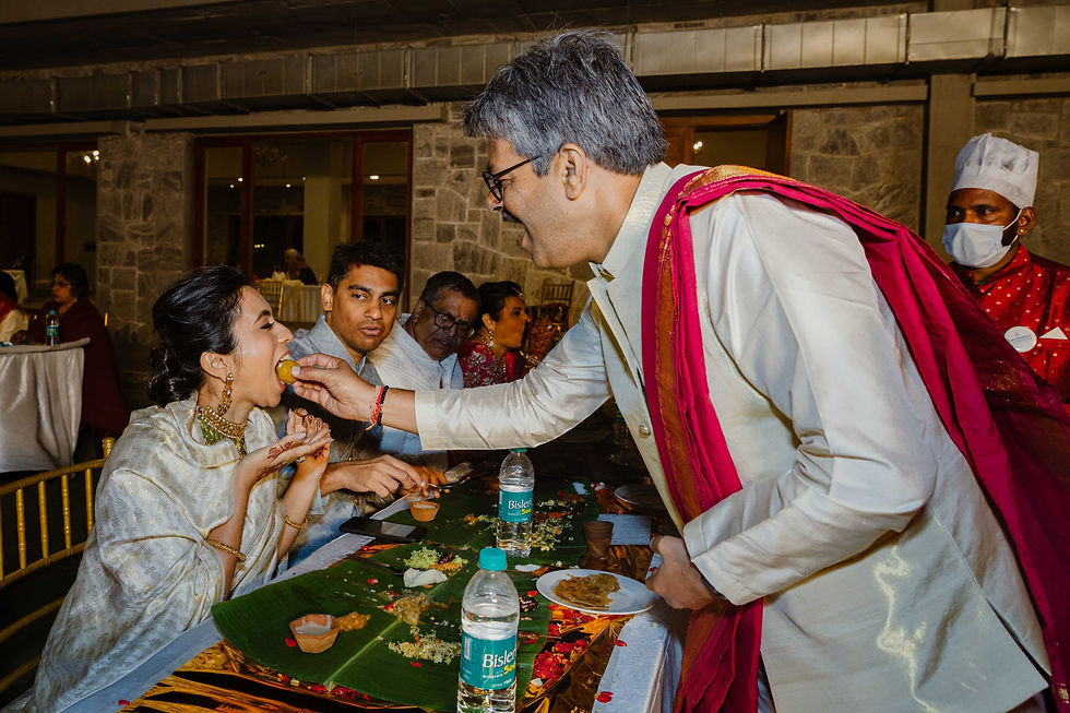 Families feeding food to each other during yele oota dinner