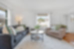 Living room with modern decor, flat-screen TV, and plants