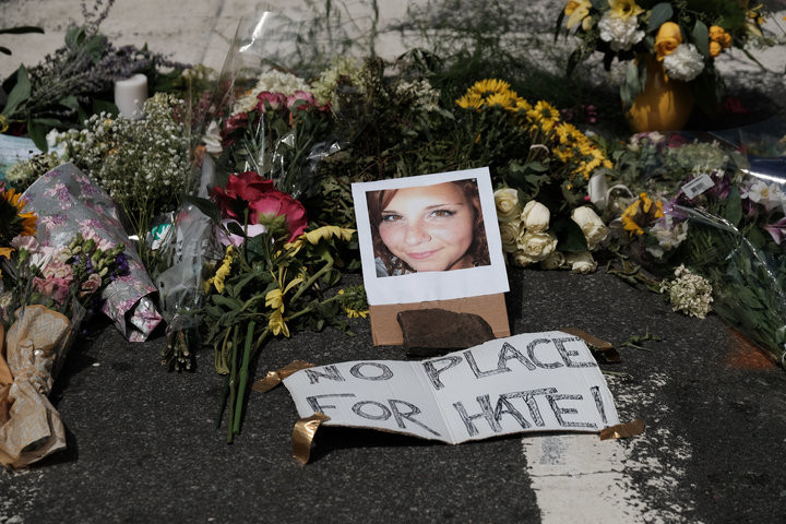 JUSTIN IDE / REUTERS Flowers and a photo of car-ramming victim Heather Heyer lie at a makeshift memorial in Charlottesville, Virginia.