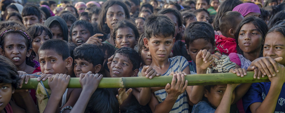 Rohingya Muslim children, who crossed over from Myanmar into Bangladesh, wait to receive aid during a distribution near Balukhali refugee camp, on September 25. Picture: AP