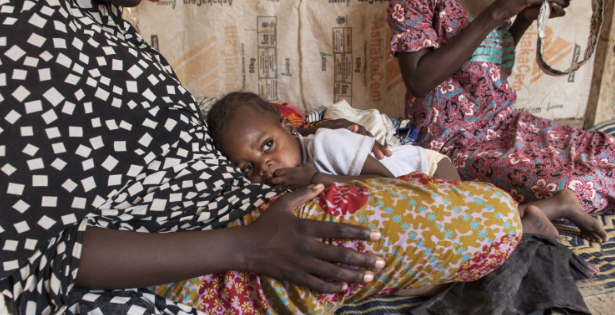 Halima, 15, holds Hauwa, the baby of her friend Hamsatu, 25, who is sewing a prayer cap in their tent in Maiduguri, Nigeria. Both women were abducted, held captive and forced into marriage by Boko Haram. (Jane Hahn/For The Washington Post)