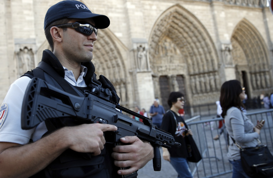 A French police officer stands guard in front of Notre Dame Cathedral in Paris on Sept. 9. (Christophe Ena/Associated Press)