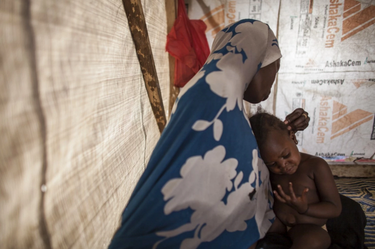Hamsatu plays with daughter Hauwa at the Dalori displacement camp. She says she was forced to travel on foot and on the backs of motorcycles to the Sambisa Forest, where Boko Haram had set up camps for its sex slaves. (Jane Hahn/For The Washington Post)