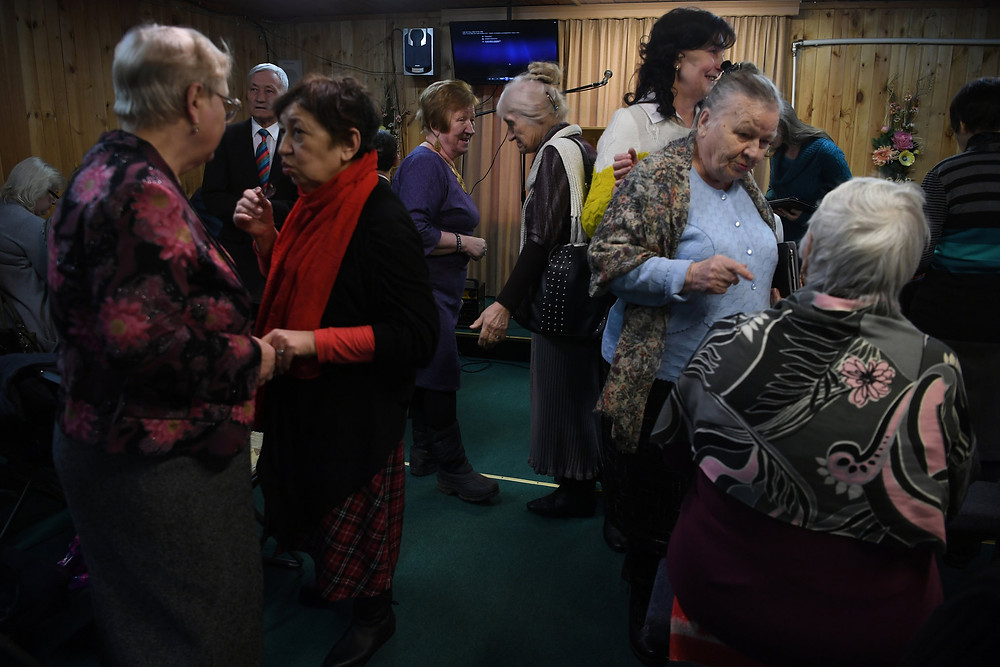 Jehovah’s Witnesses gathered in a house in the village of Vorokhobino, north of Moscow, where they meet for services. Credit James Hill for The New York Times