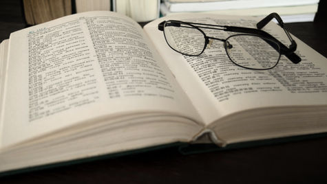 Glasses resting on an open page in a book
