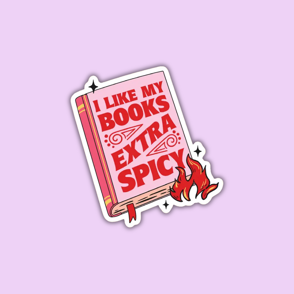 A vinyl sticker with a red and black design, featuring text 'I LIKE MY BOOKS EXTRA SPICY' and flame graphics, on a pink backg