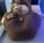 Brown crochet purse with a silk scarf, button closure, and handle. Shell Purse.