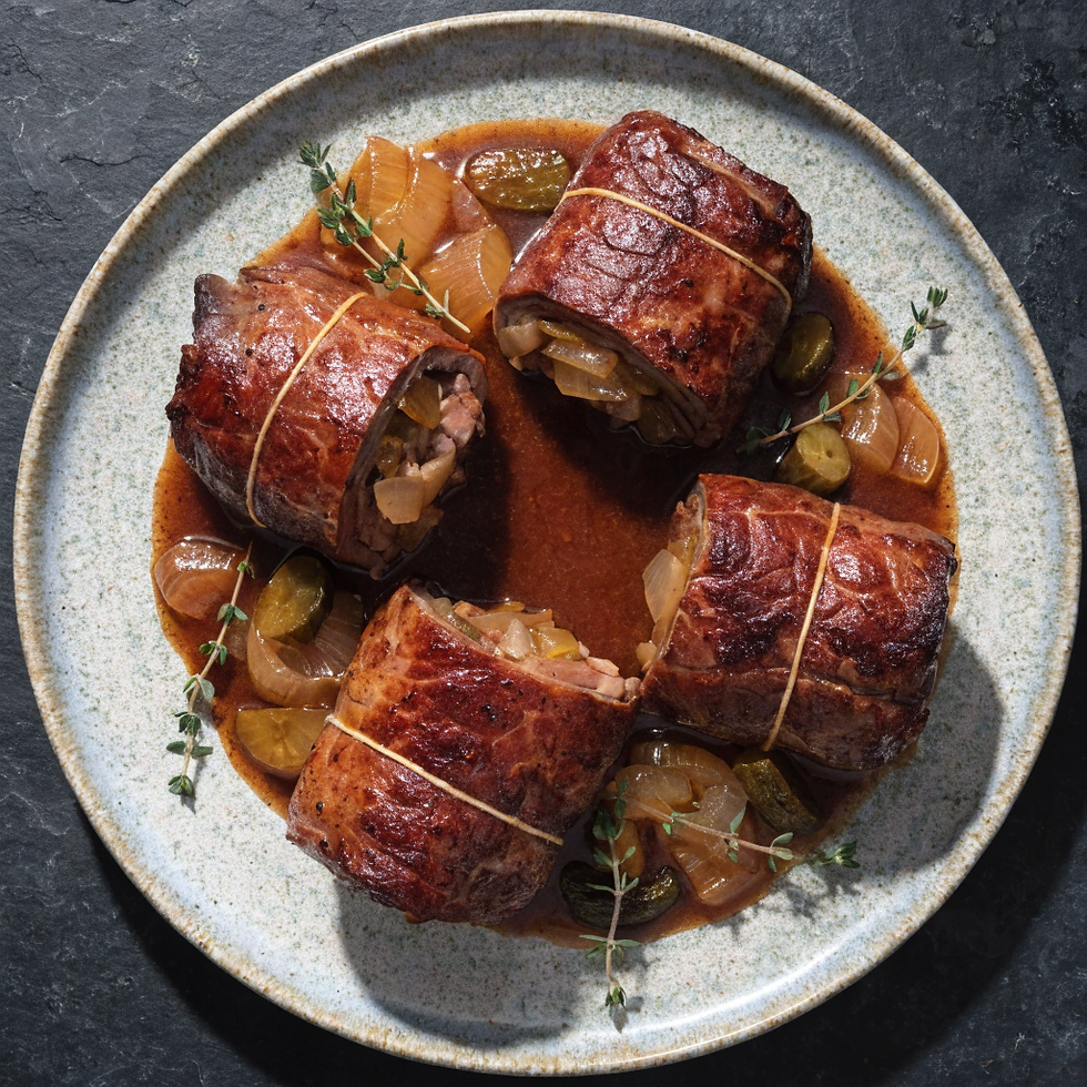 Thin beef rolls filled with bacon, onions, and pickles, slowly braised in a savory gravy.