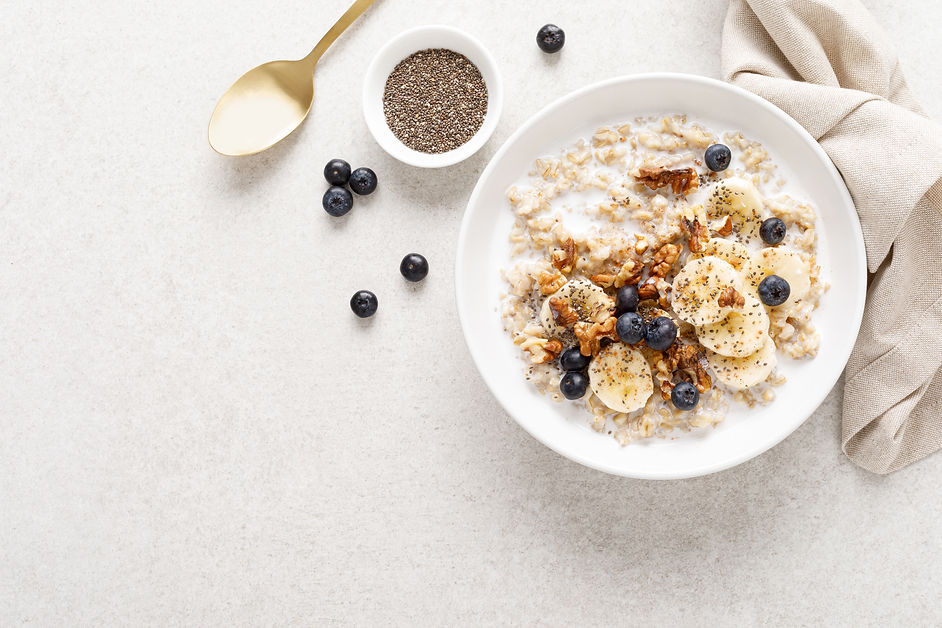 Oatmeal bowl. Oat porridge with banana, blueberry, walnut, chia seeds and almond milk for