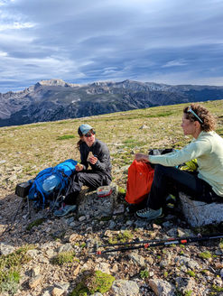 Two women having a break while backpacking Beartooth Mountains