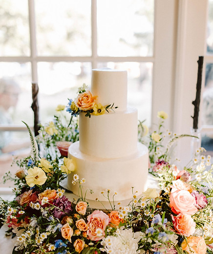Wedding cake surrounded by flower meadow