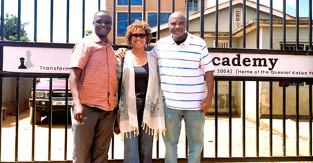 Rhonda G. Mincey and Doug Mincey with Robert Katende at the SOM Chess Academy in Uganda, symbolizing faith-driven leadership.