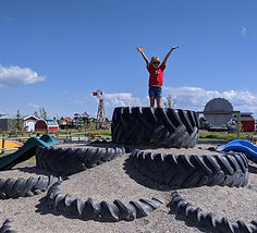 A young girl on top of Calgary's tire mountain.