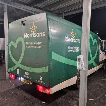 Supermarket fleet vehicle on UPLIFT TRANSPORT trailer during fleet transport to Glasgow, Scotland.