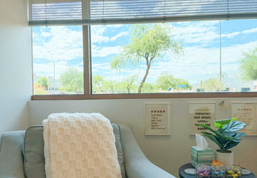Comfortable therapy chair in sunlit Scottsdale office of WholeChild Wellness