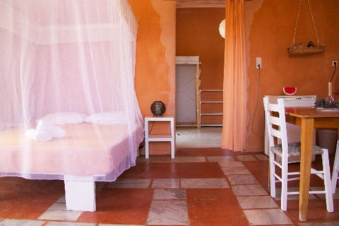 Cozy interior of a room suite in warm peach colors, offering a welcoming and serene atmosphere for participants of the Feminine Wholeness Retreat.