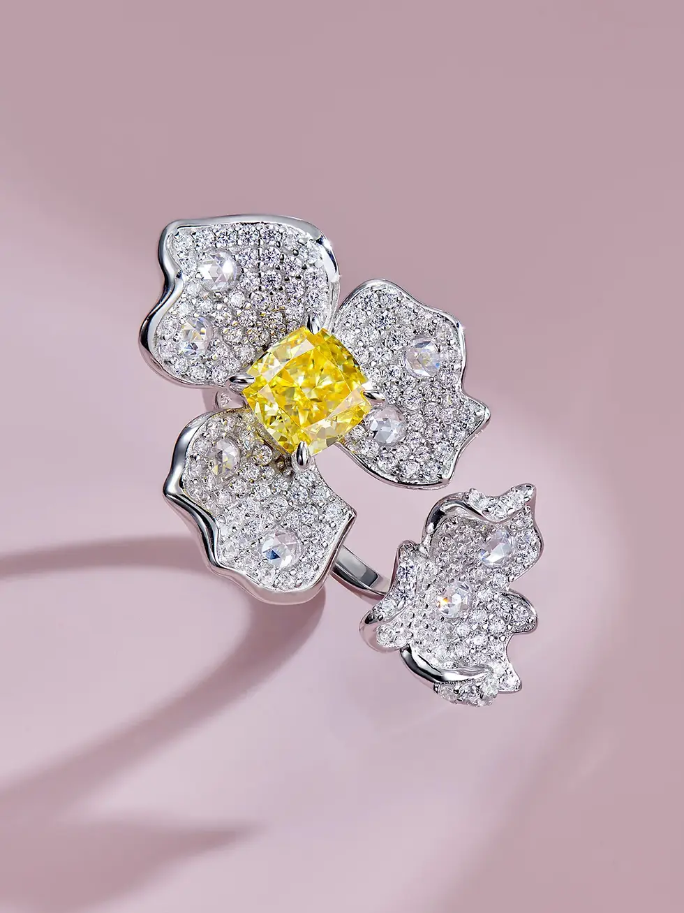 BOODOO CO Flower Shaped Pave-Set Ring with Finest Diamond Alternatives. Image of a stunning flower-shaped ring from BOODOO CO, featuring pave-set zirconia crystal moissanite finest diamond alternatives. Crafted with precision using high-quality materials, including 18K gold plated 925 silver, this ring adds a touch of luxury and sophistication to any outfit. Perfect for jewelry lovers who appreciate fine craftsmanship and exquisite design, this ring is a must-have statement piece. Shop now and elevate your jewelry collection with BOODOO CO's Flower Shaped Pave-Set Ring with Finest Diamond Alternatives