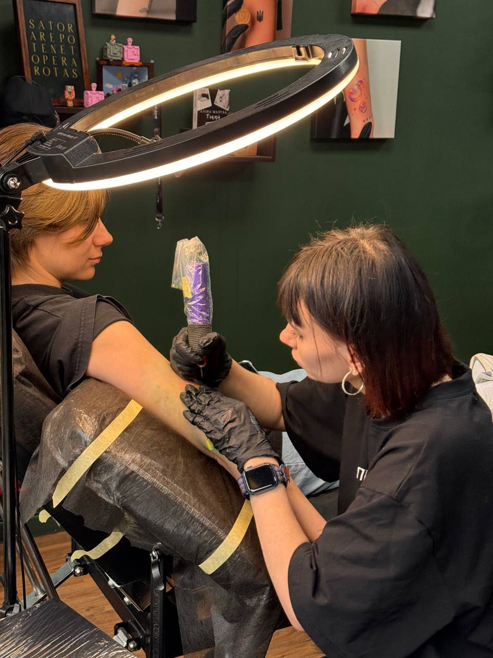 Eye-level view of a tattoo studio with various tattoo designs on display