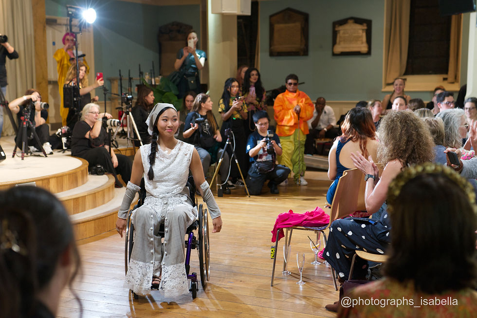 Woman in wheelchair on stage at fashion show