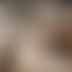 Under-construction apartment interior with multiple workers installing a false ceiling, doing carpentry work on wooden panels, and fixing electrical wiring simultaneously, showing coordinated interior execution in progress.