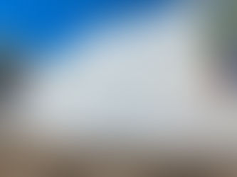 Stacked Almar-branded shipping containers at an industrial storage depot