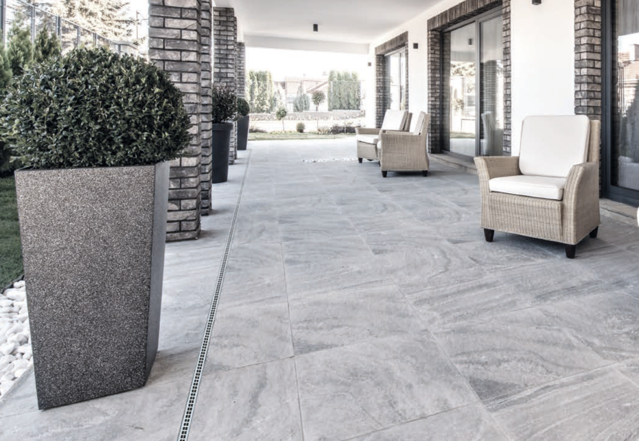 CMSA installation of MEA TopSlot drainage systems along the exterior plaza of a modern commercial building for discreet 