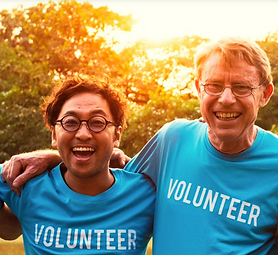 Picture of two men smiling wearing blue volunteer t-shirts