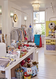 Image of the inside of a white store filled with children's toys and clothing