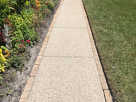 tan natural flakes for concrete coated front walkway in palm coast