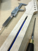 Truss rod installation -  the image shows a partially completed Malone Guitars electric guitar neck. The neck is made from birds eye maple.