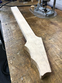 Neck blank shaped for carving  - a guitar neck blank ready to be carved. The blank is made from a single piece of heavily figured bird's eye maple
