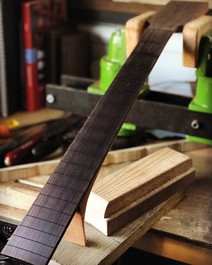 Shaping a rosewood guitar fingerboard before fret installation