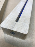 Truss rod installation-  the image shows a partially completed Malone Guitars electric guitar neck. The neck is made from birds eye maple.