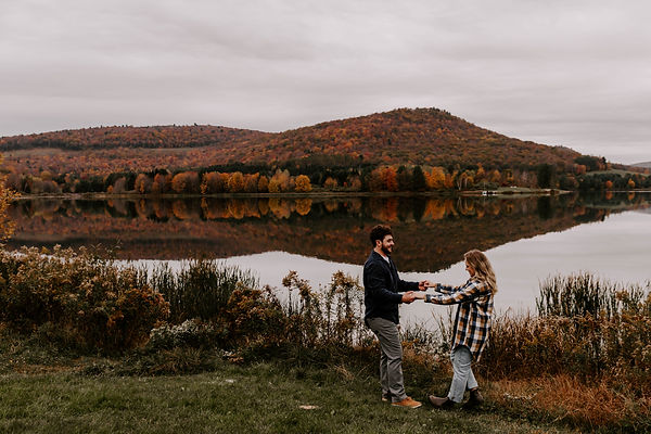 Couple playing during fall engagement session in New England