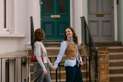Couple walking together down Notting Hill road in front of historic houses during travel session