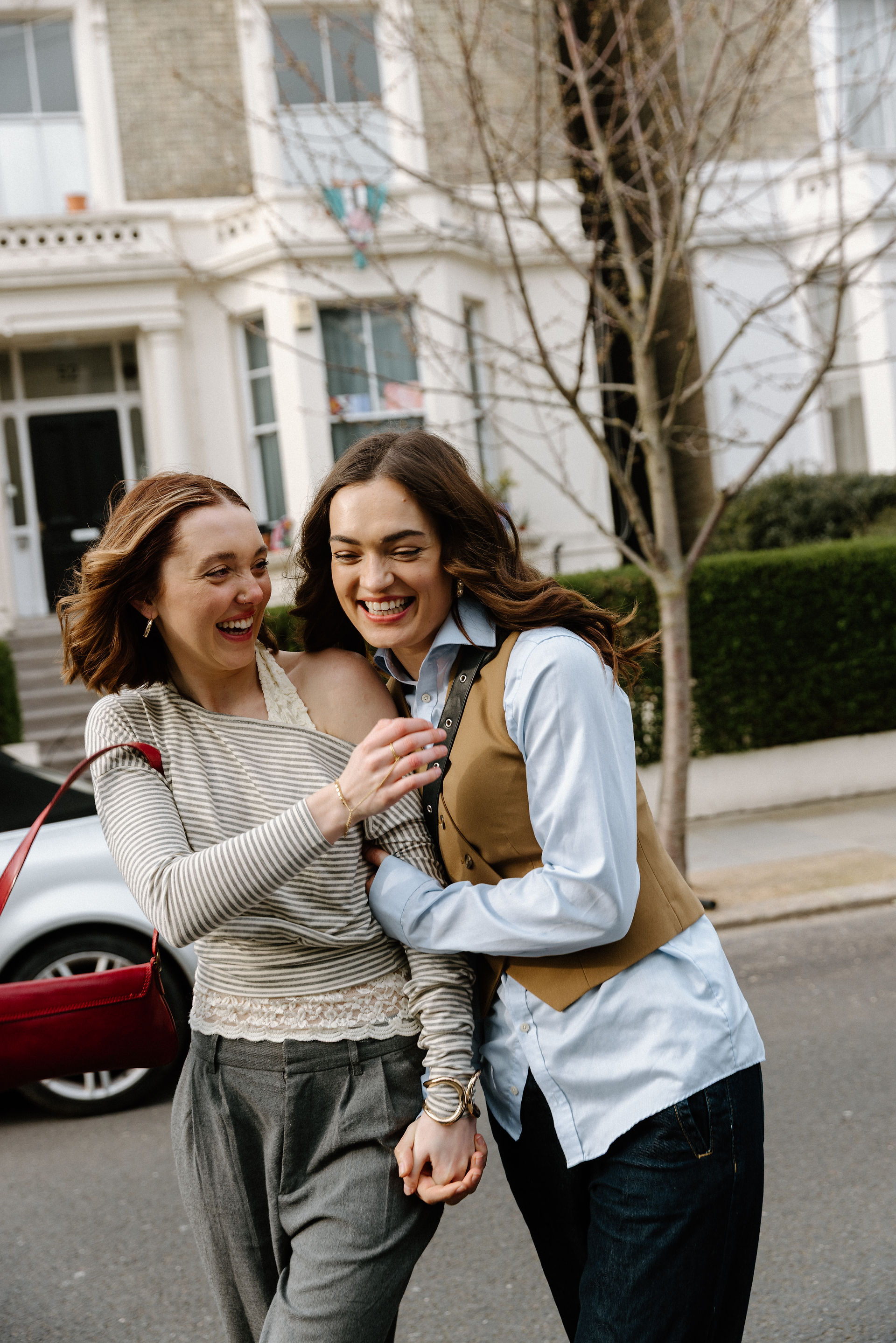 Couple laughing as they walk down a street in Notting Hill London during a travel session