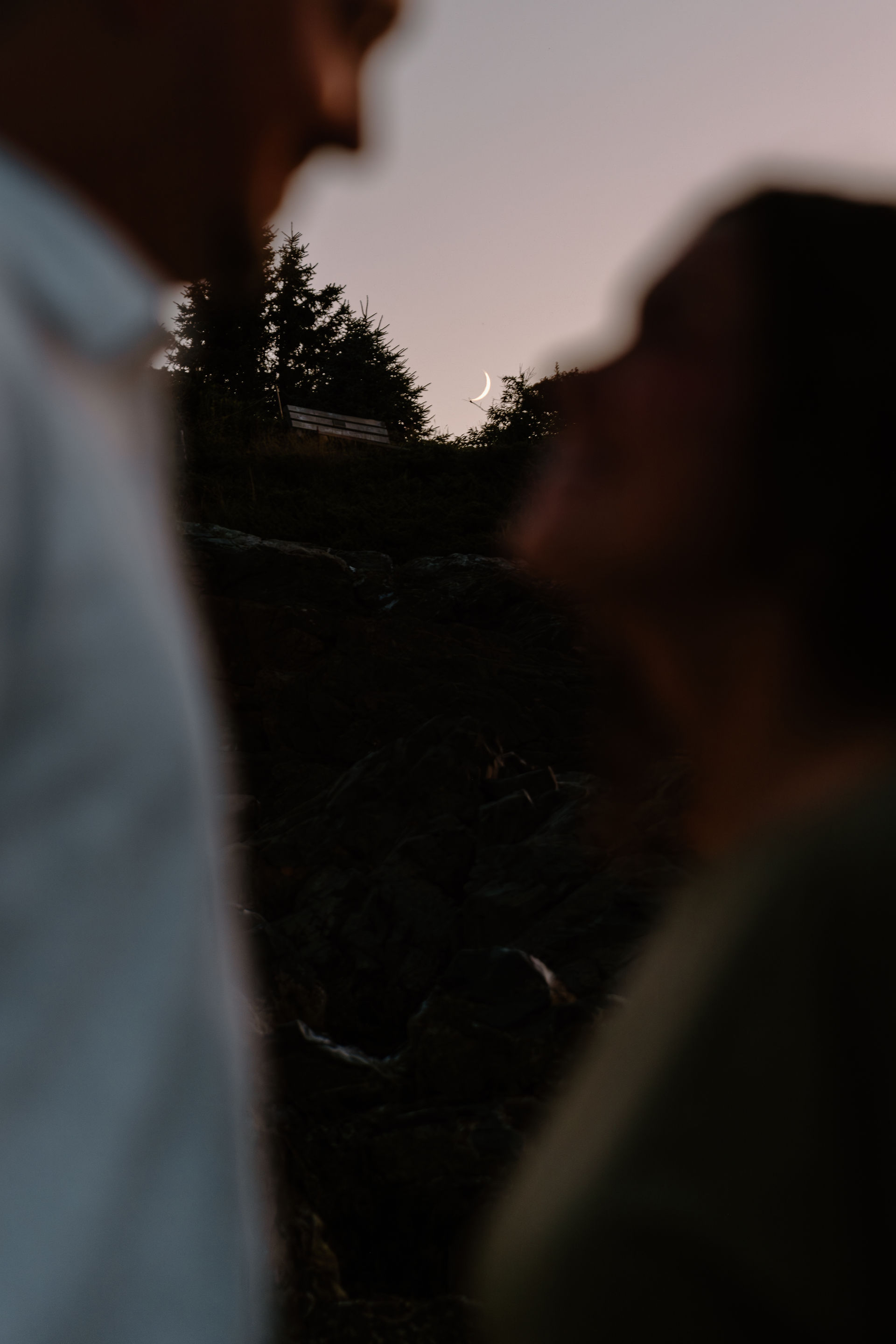 Couple engagement shoot in front of moon in Maine during destination engagement