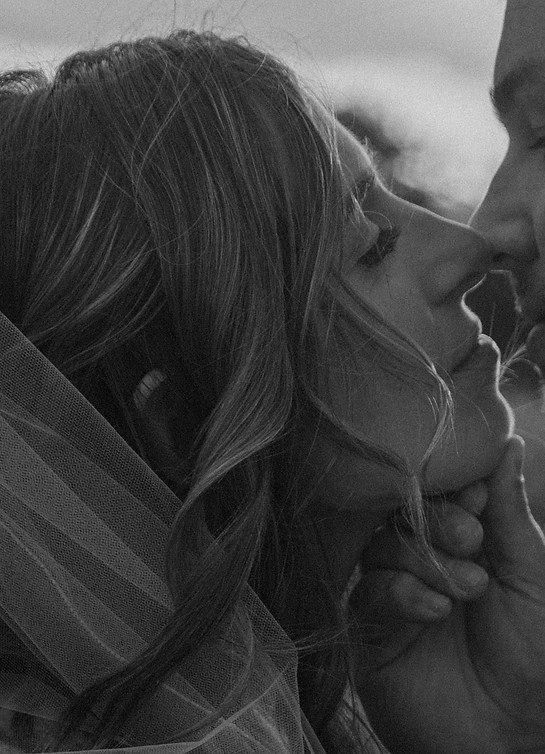 Black and white close up portrait of bride kissing groom during a European elopement in Tuscany
