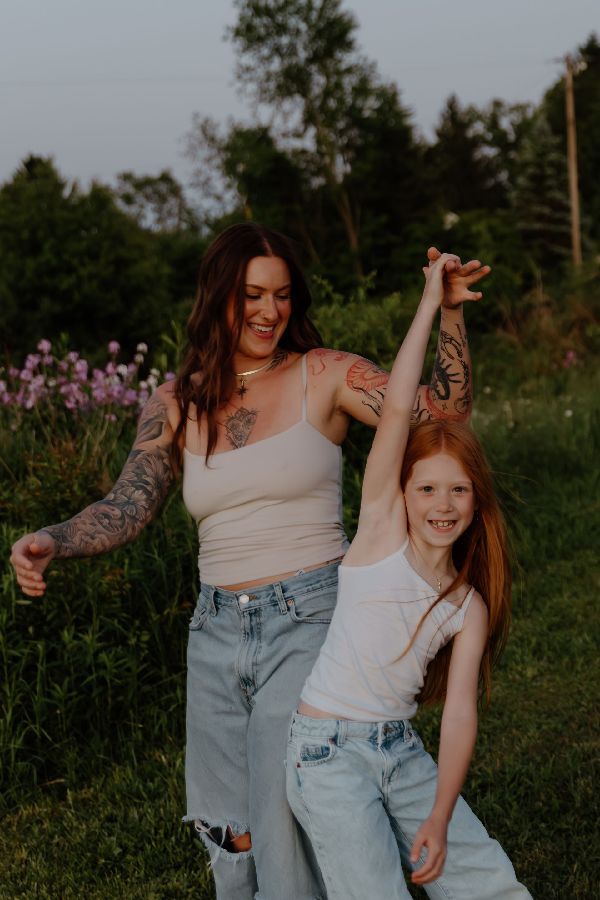 Mom and daughter playing in field during a family session in PA