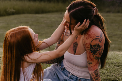 Daughter holding Mothers face during an outdoor family photoshoot in Williamsport PA