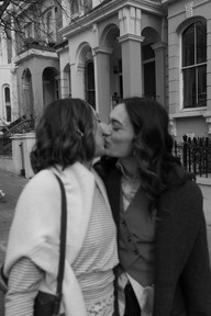 black and white photo of couple kissing in Notting Hill London during travel session