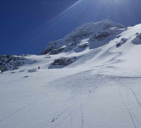 Blue skies and ski tracks in the snow