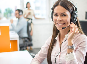 Friendly female helpline operator with headphones in call center.jpg