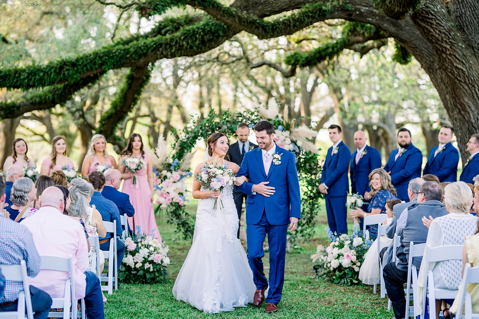 Bride and groom exiting ceremony under 100 year old oak trees at Shreveport's Venue de LaChute